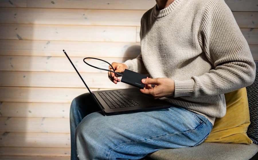A portable drive being connected to a laptop for data transfer